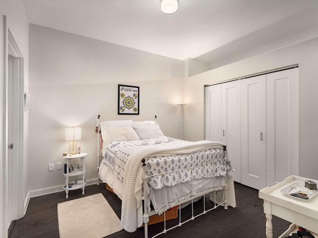 bedroom with a closet and dark wood-type flooring