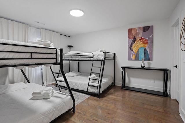 bedroom with dark hardwood / wood-style flooring