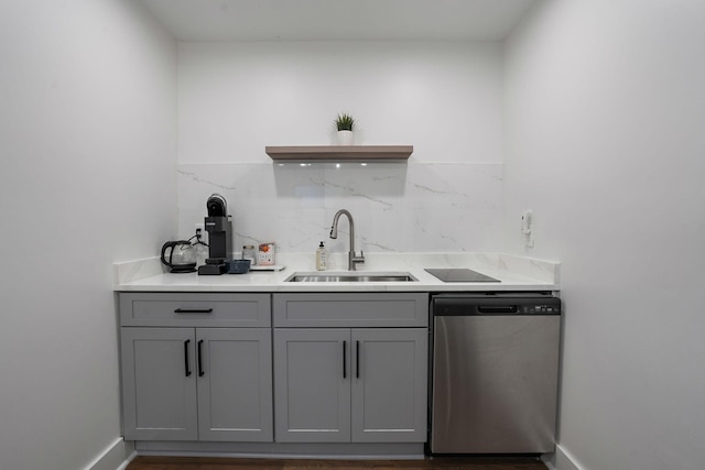 bar featuring sink, stainless steel dishwasher, and gray cabinets