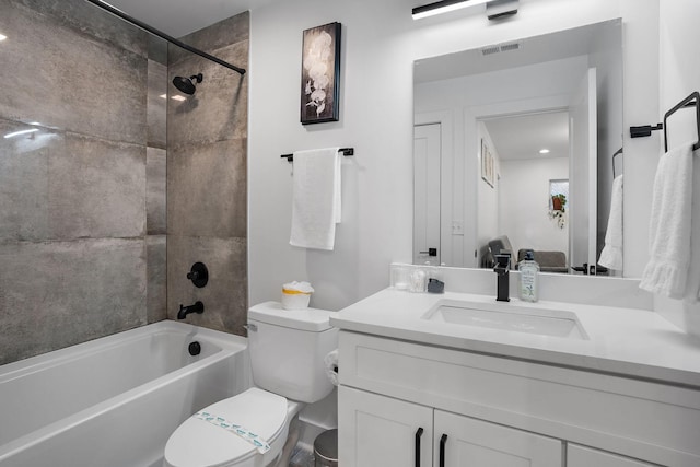 full bathroom featuring toilet, tiled shower / bath combo, and vanity