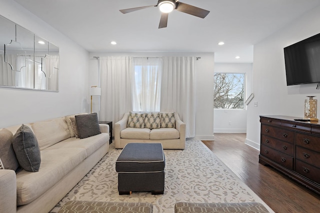 living room featuring ceiling fan, plenty of natural light, and hardwood / wood-style flooring