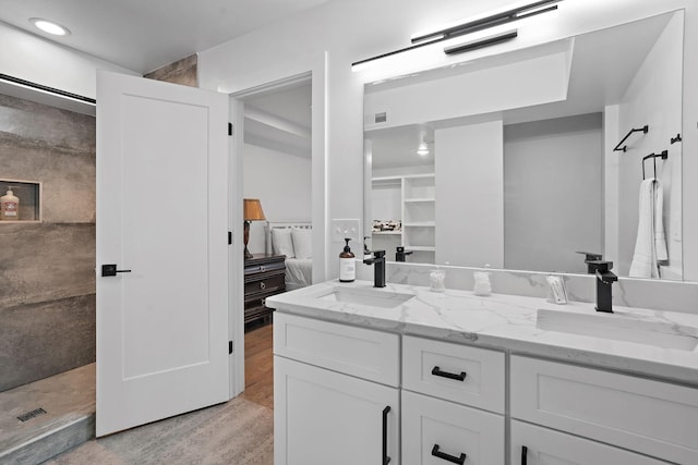 bathroom featuring a shower, vanity, and hardwood / wood-style flooring