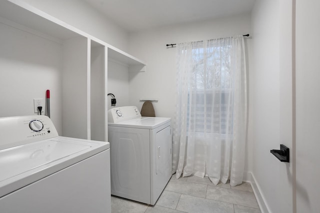 laundry area featuring washing machine and dryer and light tile patterned floors