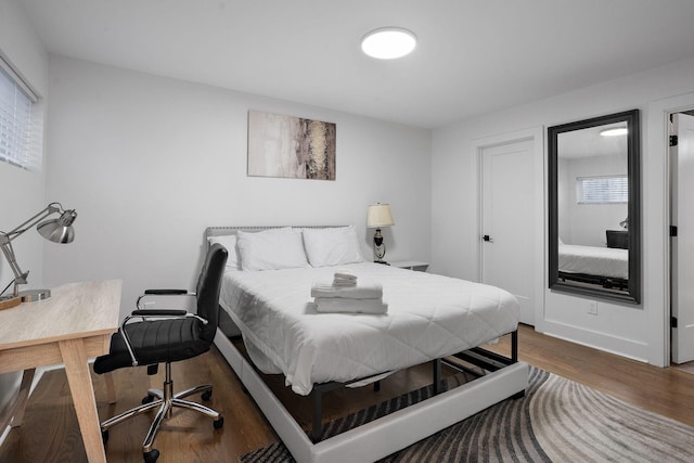 bedroom with dark wood-type flooring