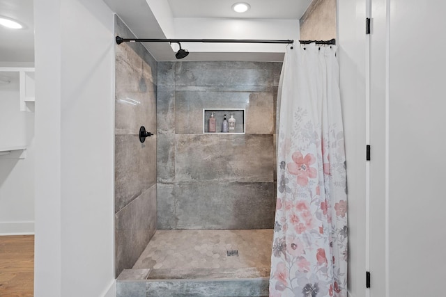 bathroom featuring walk in shower and hardwood / wood-style floors