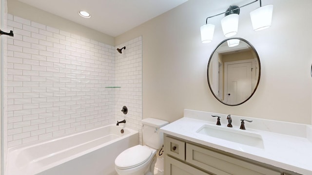 full bathroom featuring vanity, tiled shower / bath combo, and toilet