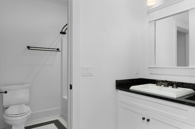 bathroom featuring tile patterned flooring, vanity, and toilet