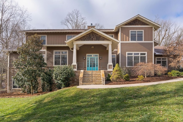 craftsman inspired home featuring a front lawn