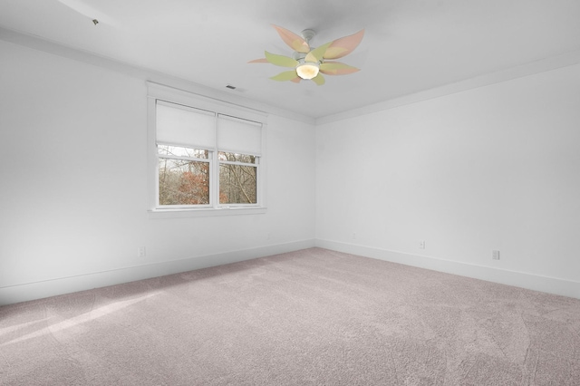 unfurnished room with ceiling fan, carpet floors, and ornamental molding