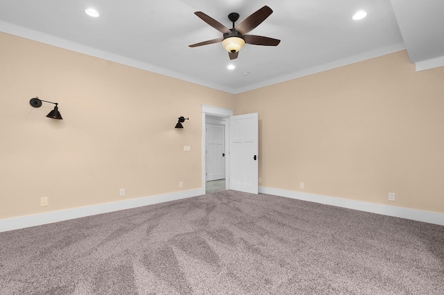 spare room with carpet flooring, crown molding, and ceiling fan