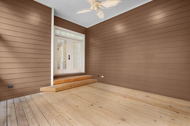 wooden terrace featuring ceiling fan and french doors