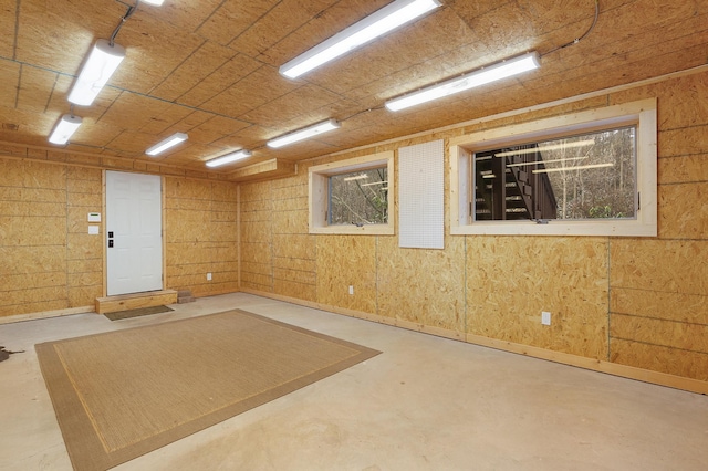 spare room featuring wooden walls