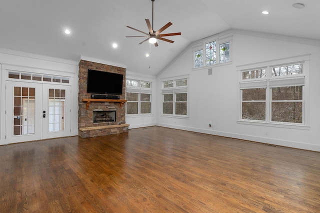 unfurnished living room featuring high vaulted ceiling, french doors, a stone fireplace, ceiling fan, and dark hardwood / wood-style flooring