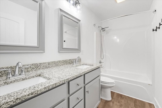 full bathroom with vanity,  shower combination, toilet, and wood-type flooring