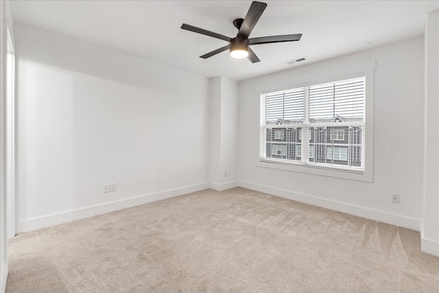 spare room with light carpet and ceiling fan