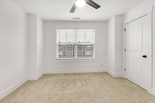 carpeted empty room featuring ceiling fan