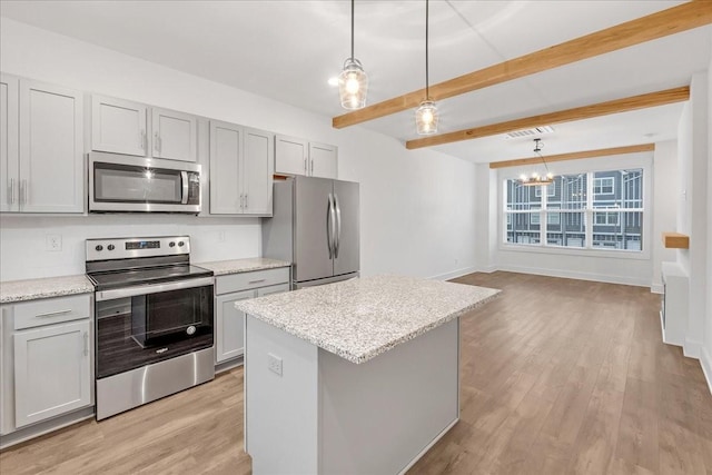 kitchen featuring light stone countertops, appliances with stainless steel finishes, decorative light fixtures, and beam ceiling