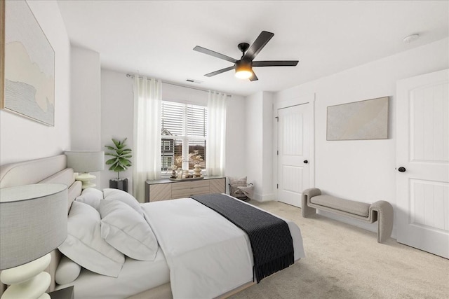 bedroom with ceiling fan, a closet, and light carpet