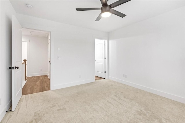 carpeted spare room featuring ceiling fan