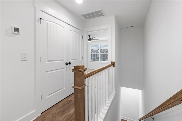 corridor with wood-type flooring