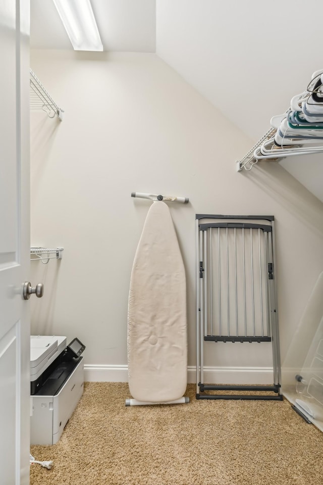 spacious closet featuring carpet floors and vaulted ceiling