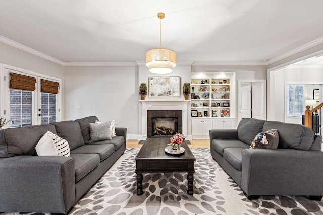 living room with a fireplace, wood-type flooring, french doors, and crown molding