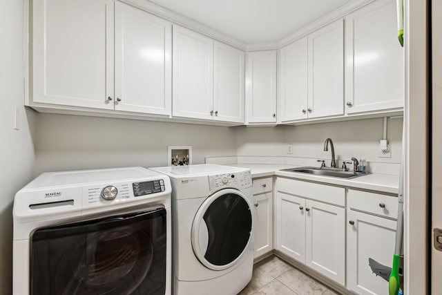 laundry room with cabinets, independent washer and dryer, light tile patterned floors, and sink