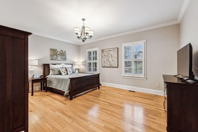 bedroom featuring a chandelier, light hardwood / wood-style floors, and ornamental molding