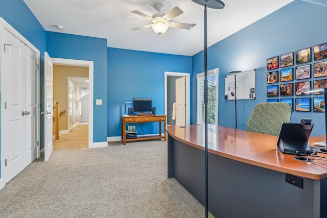 office space featuring ceiling fan and light colored carpet