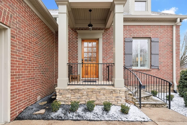 view of exterior entry with a porch