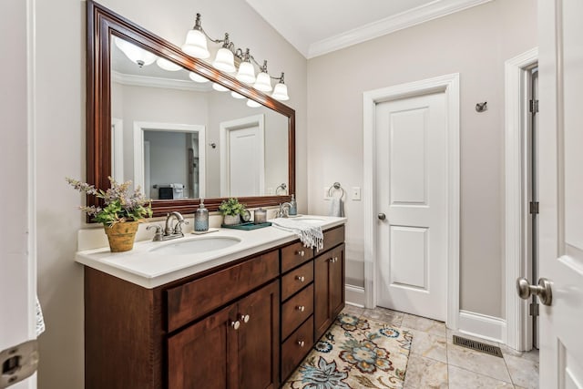 bathroom featuring tile patterned flooring, vanity, and crown molding