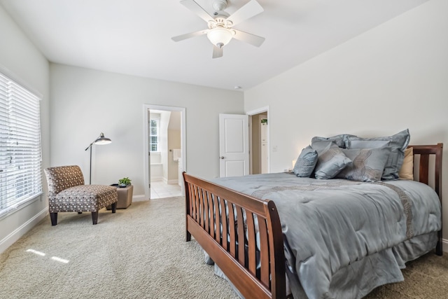 carpeted bedroom with ensuite bath and ceiling fan