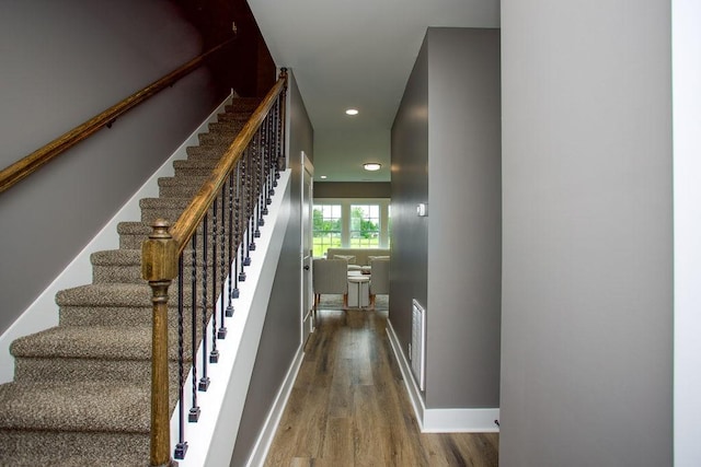 stairs with wood-type flooring