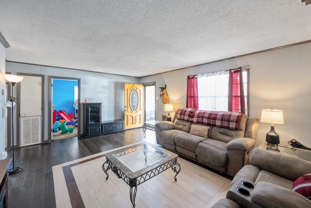 living room with hardwood / wood-style floors and a textured ceiling