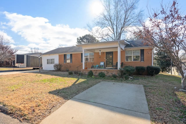 ranch-style house featuring a porch and a front lawn