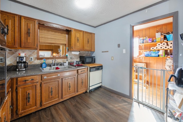 kitchen featuring dark hardwood / wood-style flooring, a textured ceiling, crown molding, sink, and dishwasher