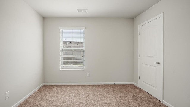 spare room with light carpet