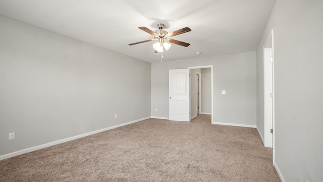 carpeted spare room with ceiling fan