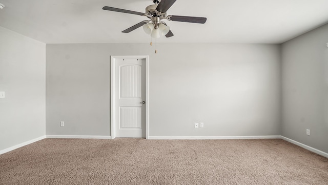 spare room featuring ceiling fan and carpet floors