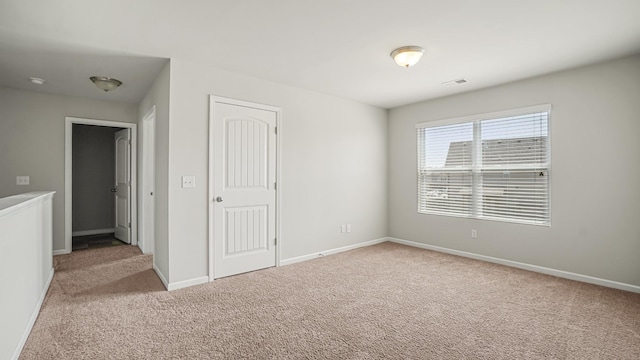 unfurnished room with light colored carpet