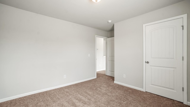 unfurnished bedroom with light colored carpet