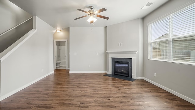 unfurnished living room with ceiling fan and dark wood-type flooring