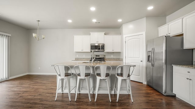 kitchen with white cabinetry, a kitchen island with sink, and stainless steel appliances