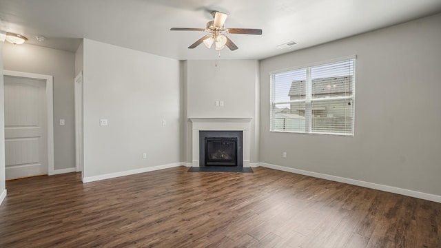 unfurnished living room with ceiling fan and dark wood-type flooring