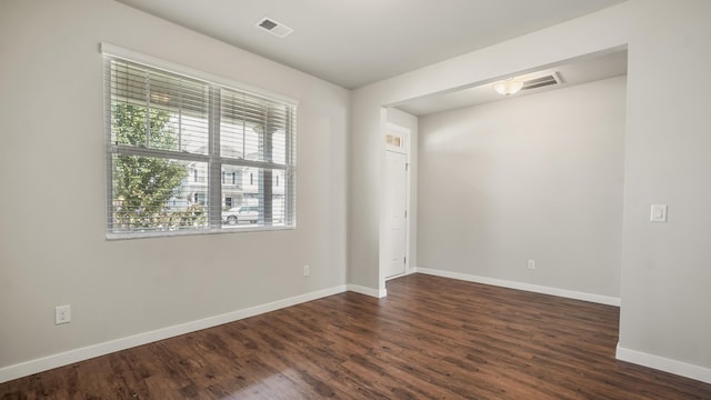 spare room with dark hardwood / wood-style flooring