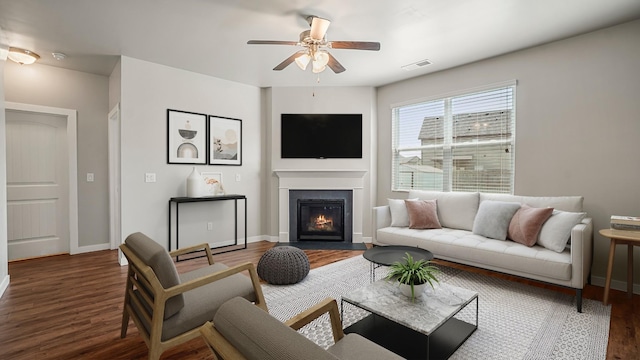 living room featuring dark hardwood / wood-style floors and ceiling fan