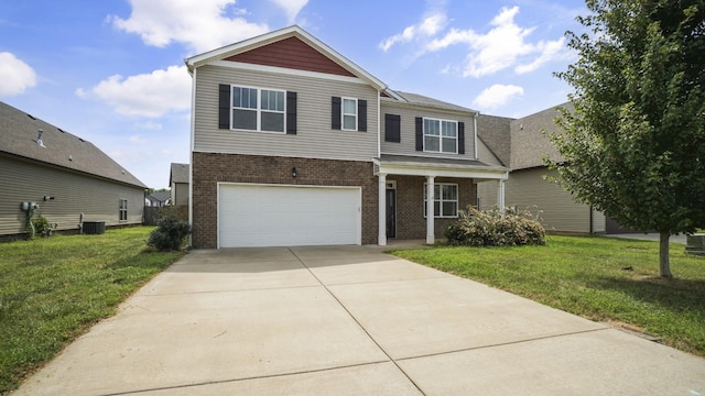 view of front property featuring cooling unit, a front yard, and a garage