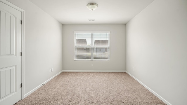 spare room with light carpet