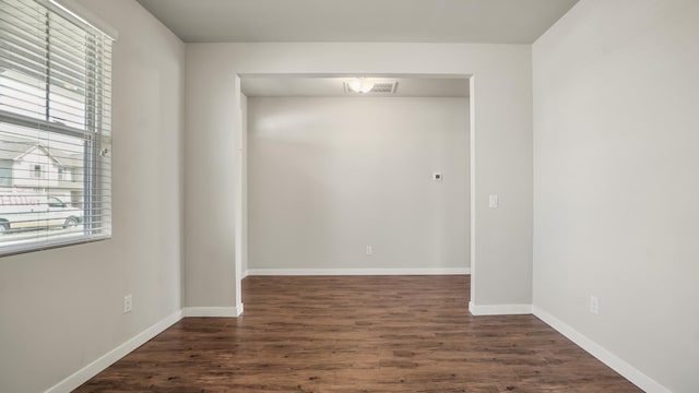 unfurnished room featuring dark hardwood / wood-style floors and a healthy amount of sunlight