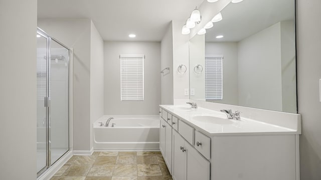 bathroom featuring vanity and shower with separate bathtub